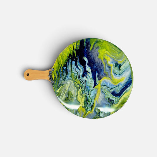 A round serving platter with a light wood handle, featuring a vibrant green, blue, and black fluid art pattern, shown on a light gray background.